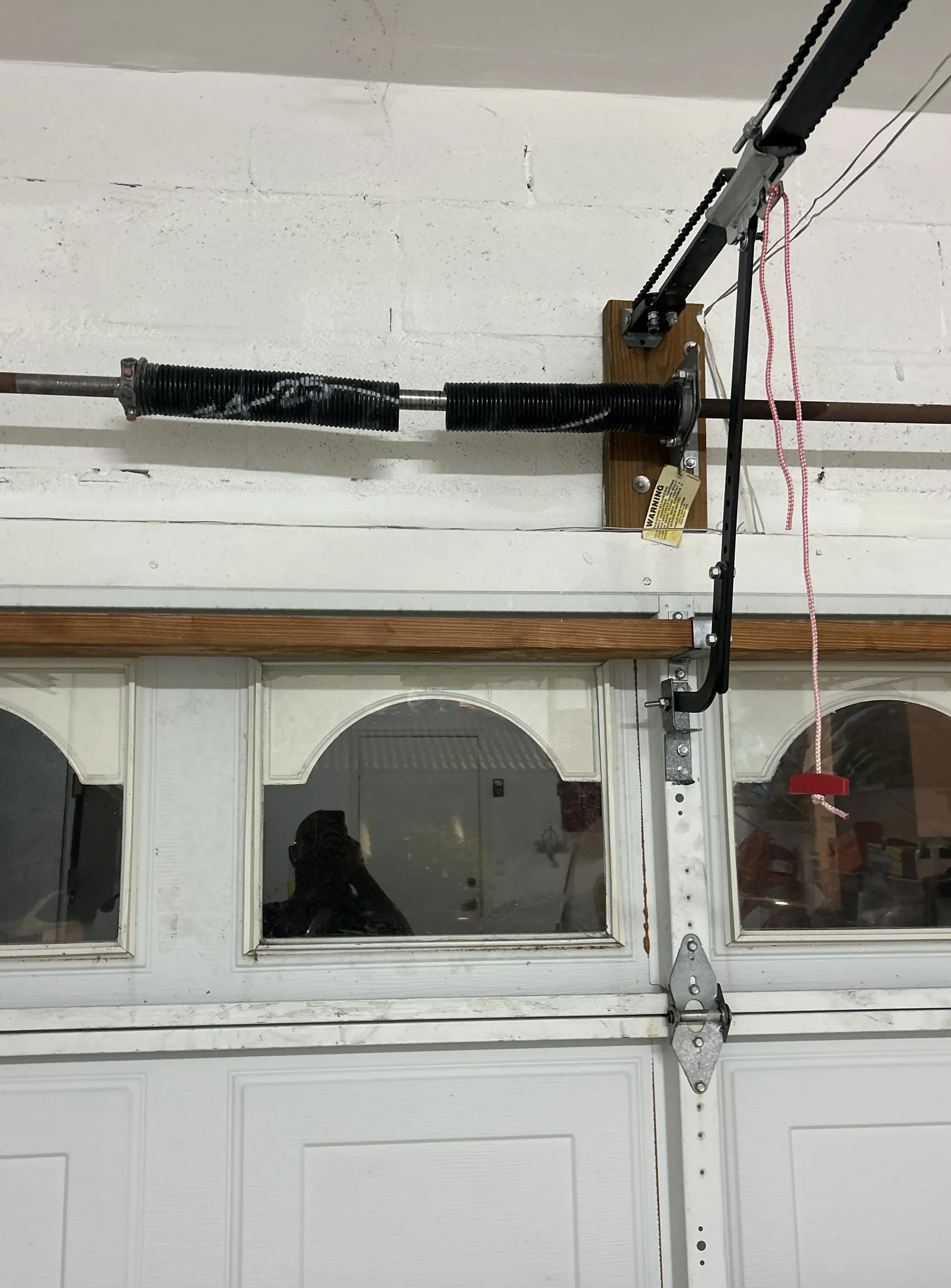 Broken torsion spring above a sectional garage door