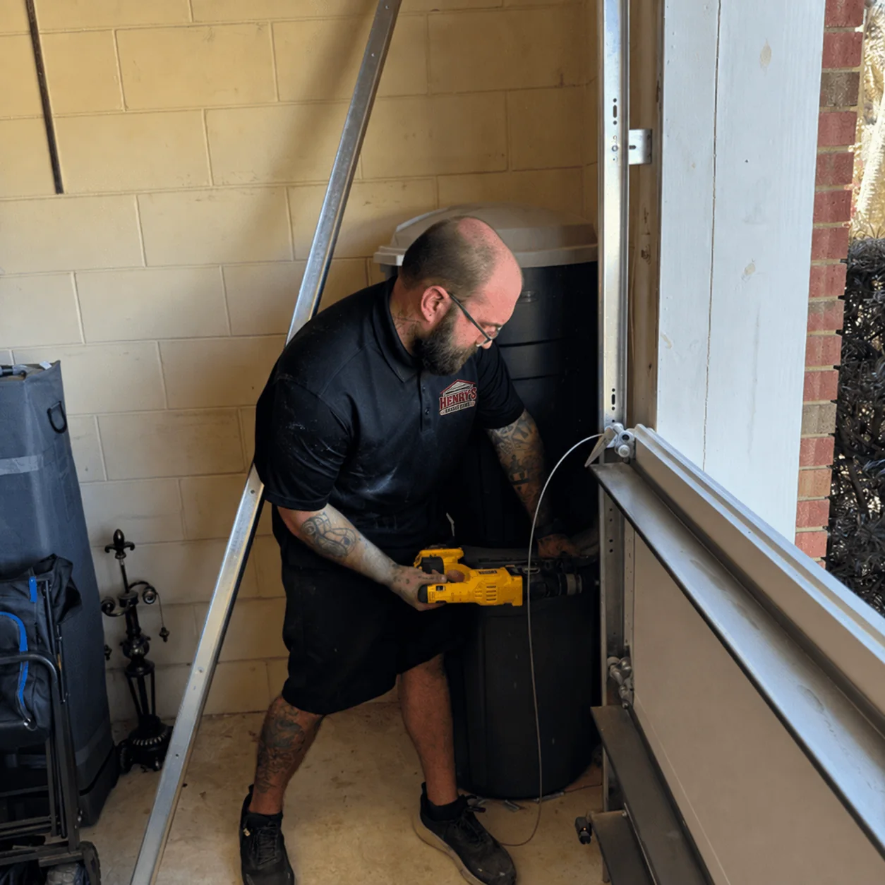 Garage door track service with Henry’s branded workwear