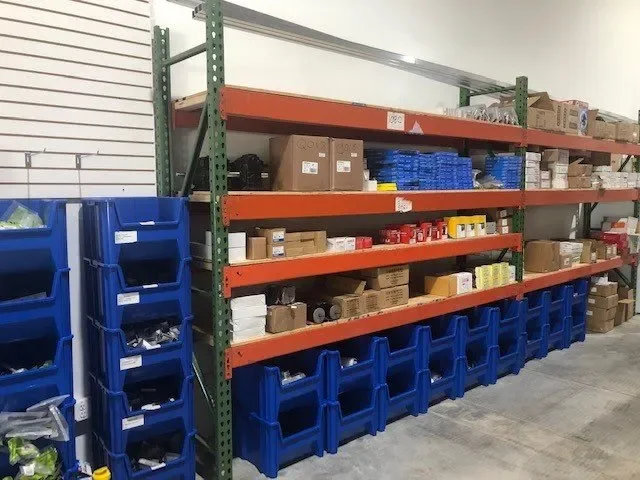Garage door hardware and parts stored on organized shelves